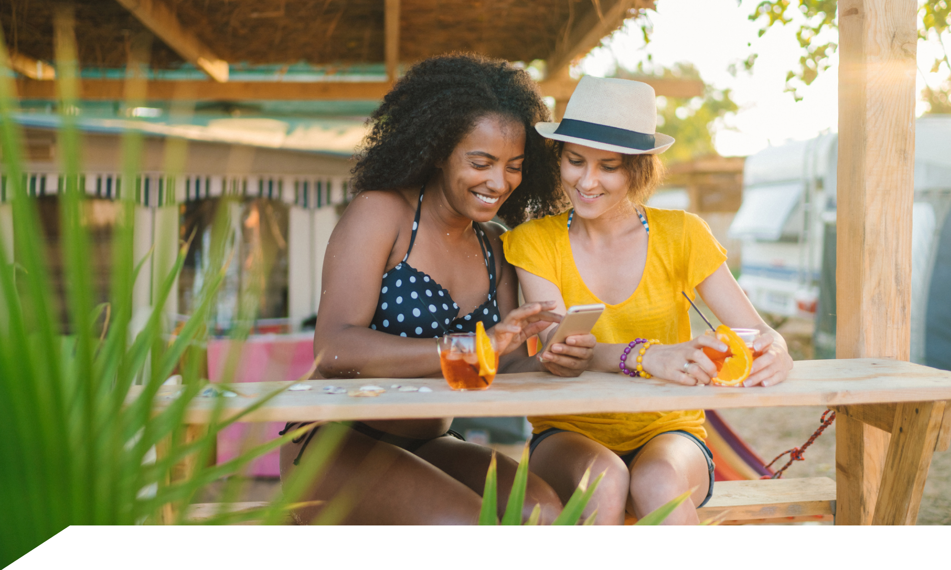 Two women traveling looking at smartphone 