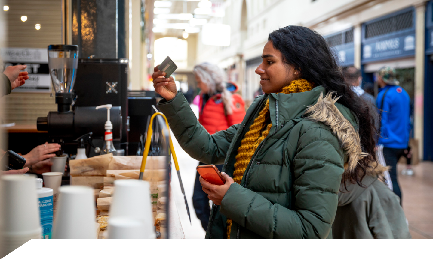 woman buying coffee with her credit card 