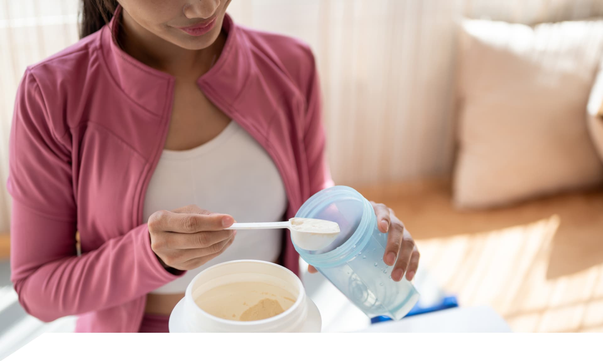 woman pouring protein powder