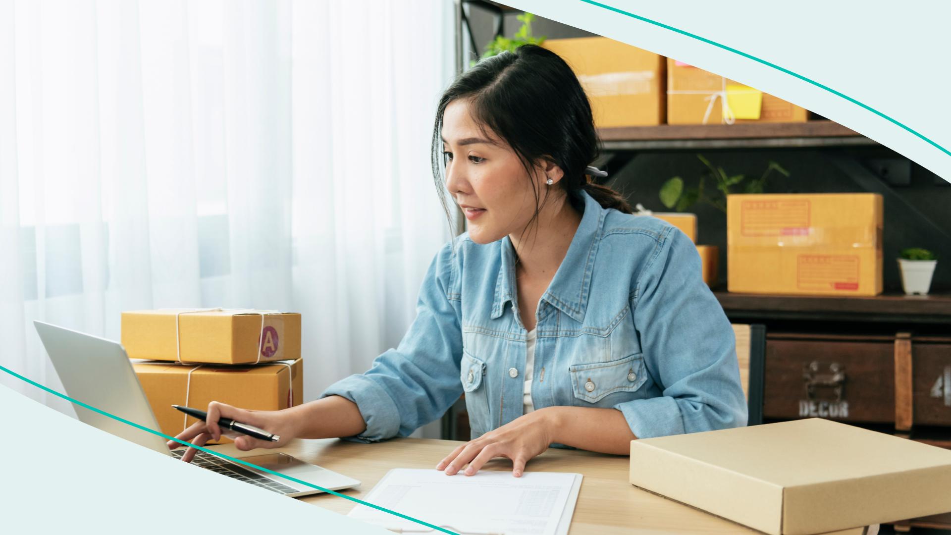 woman sitting at a laptop surrounded by packages