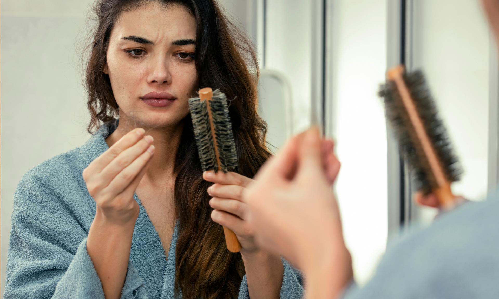 woman finding hair on brush