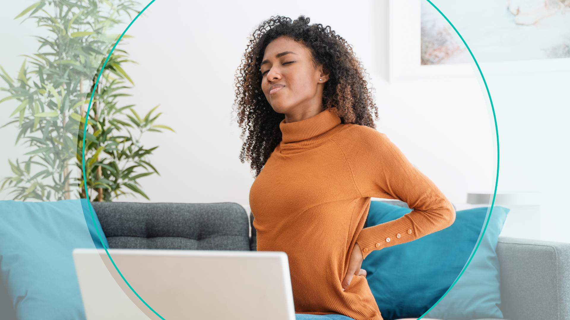 Woman stretching out back sitting on couch 