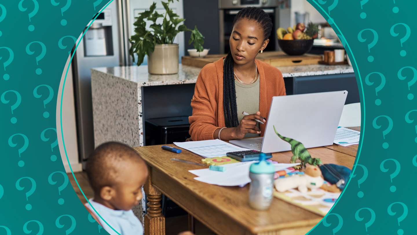 Woman works at a table with child nearby