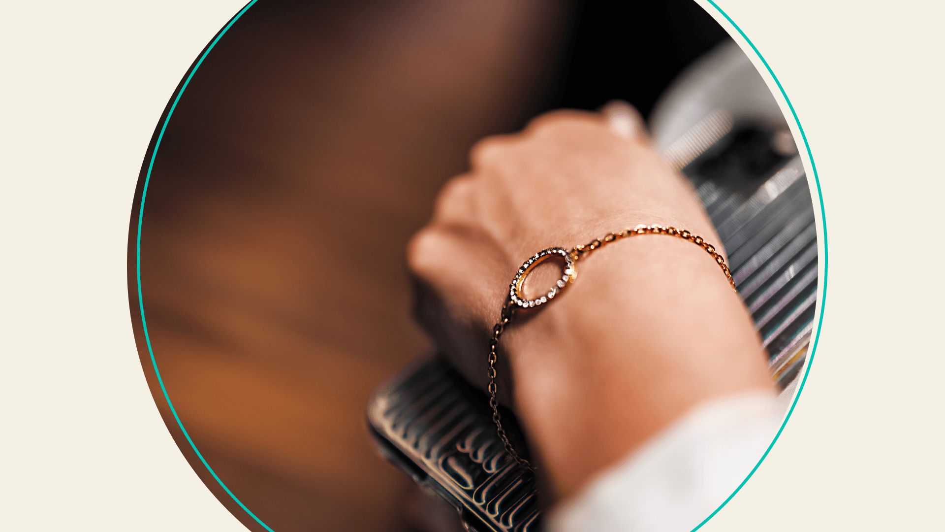 A person's wrist wearing a gold bracelet