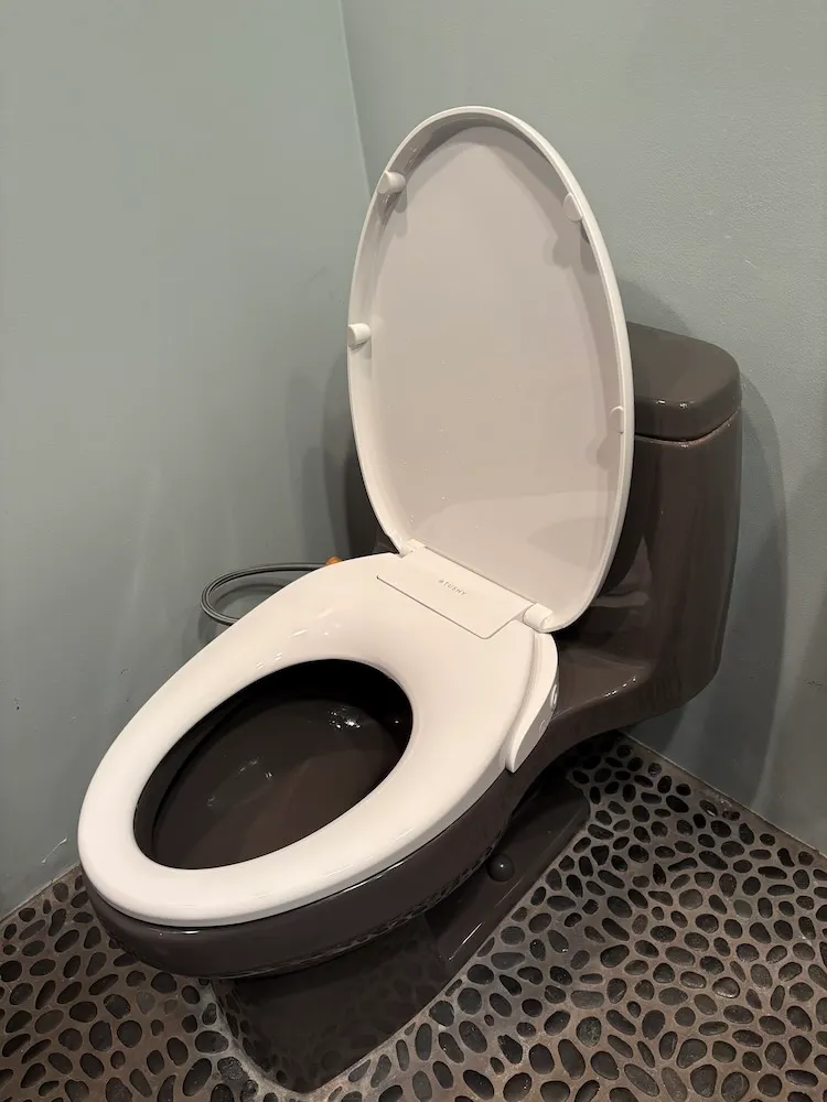 Tushy bidet seat installed on gray toilet
