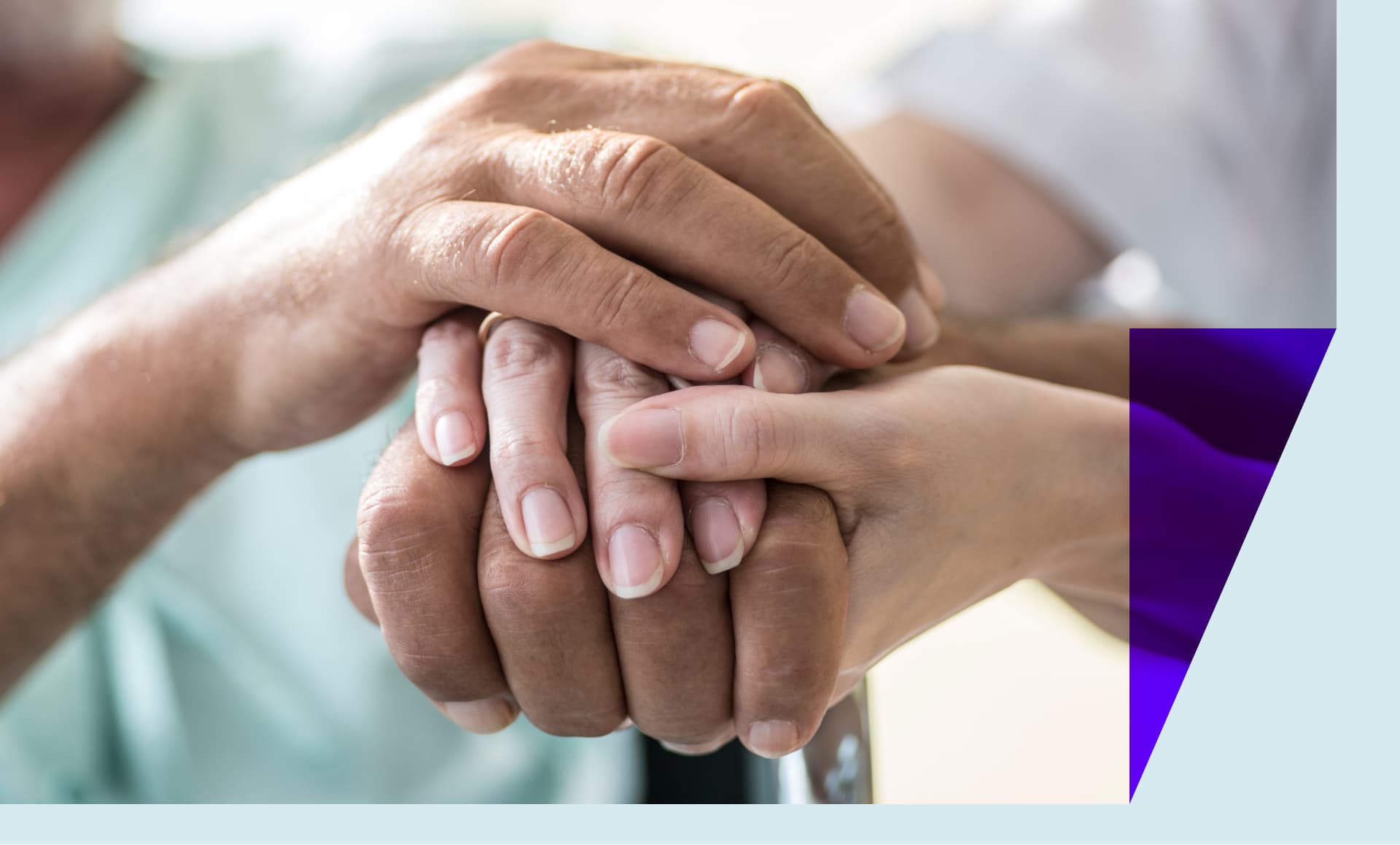 Home care giver holding hands with patient