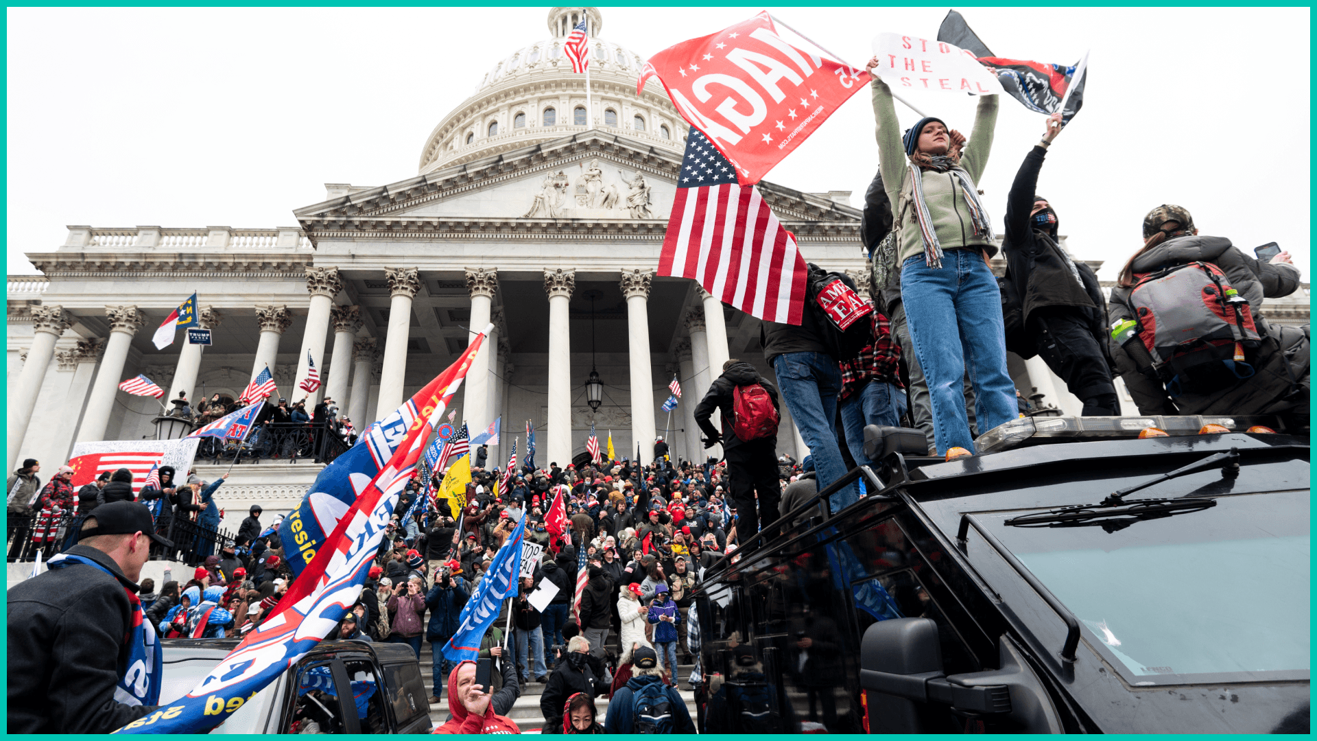 Trump supporters stand on the U.S. Capitol Police armored vehicle as others take over the steps of the Capitol