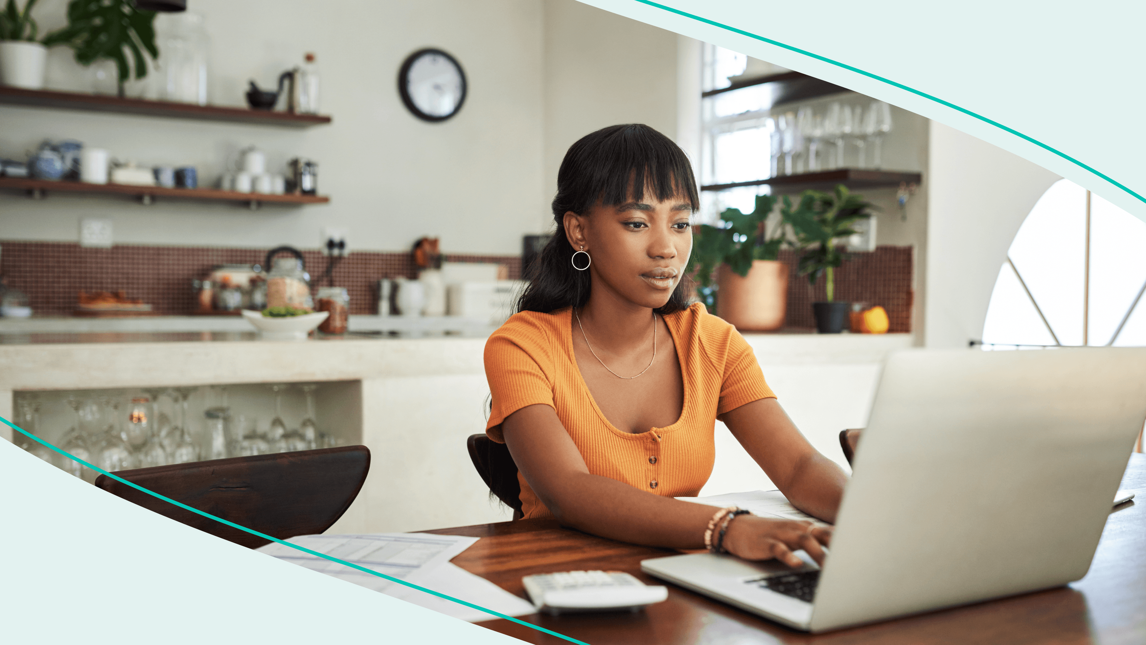 A woman on a laptop in a kitchen