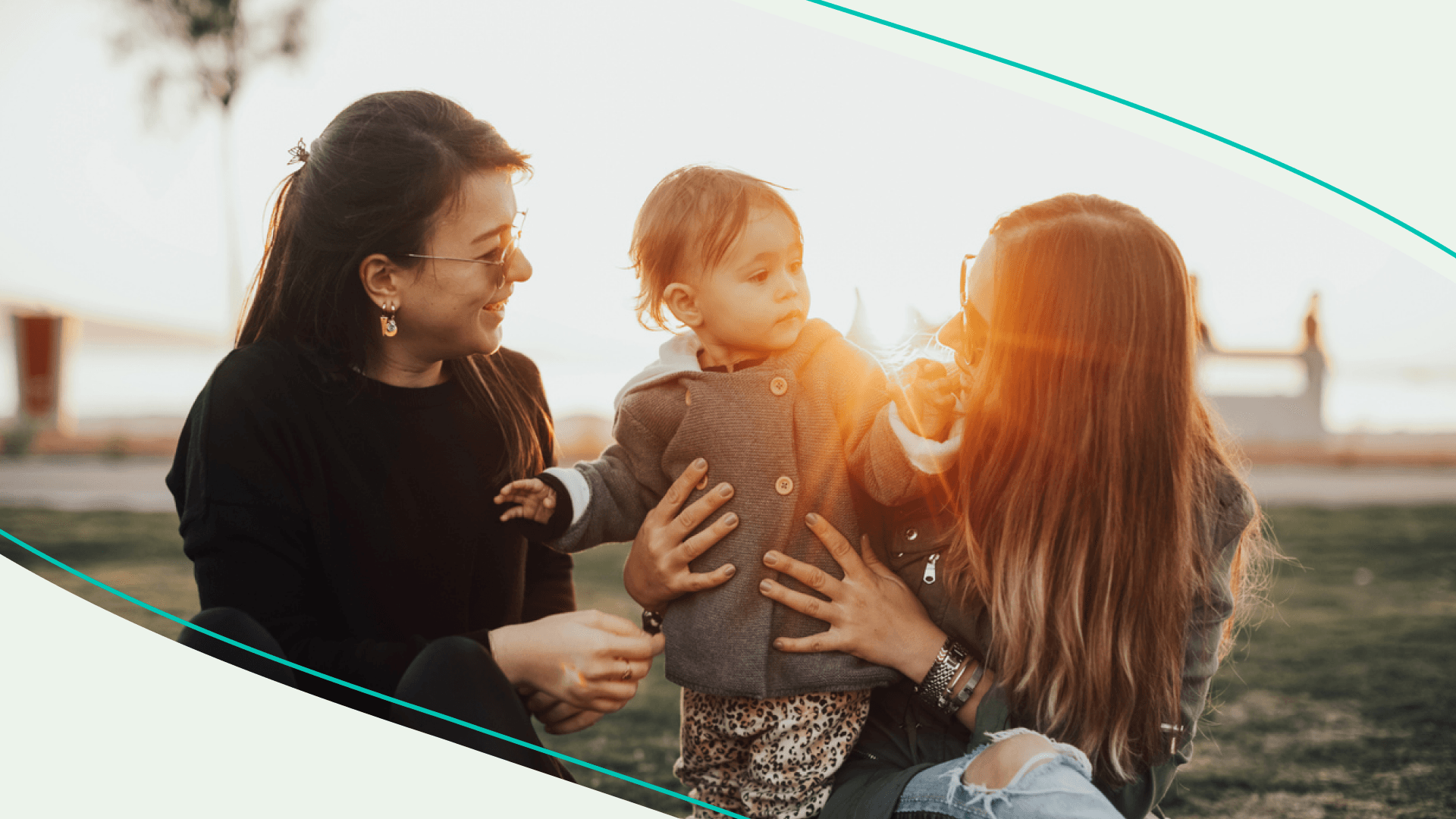 Two women playing with a child