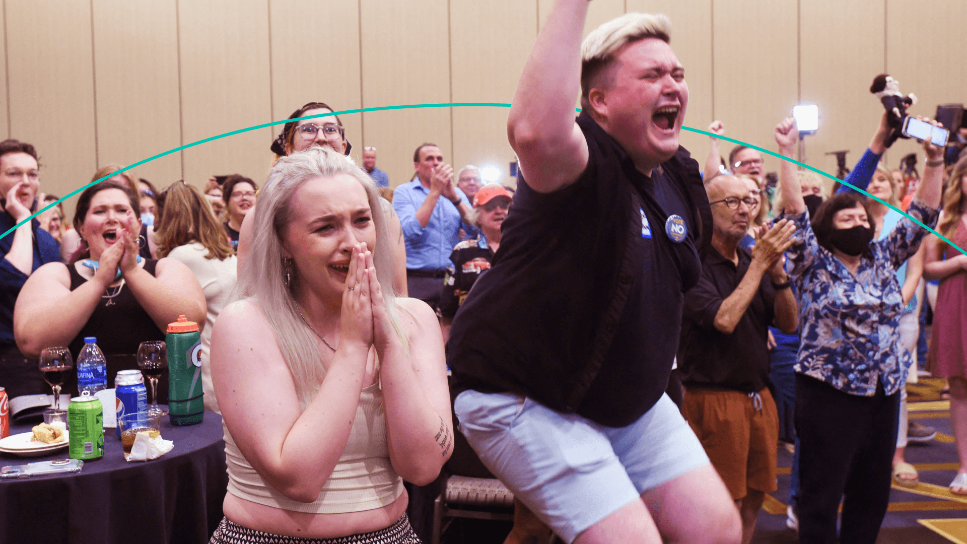 A room full of people reacts to the Kansas election results