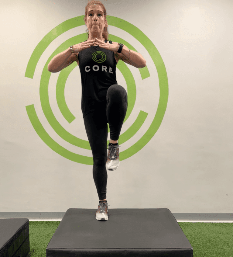 Personal trainer demonstrating step-up exercise