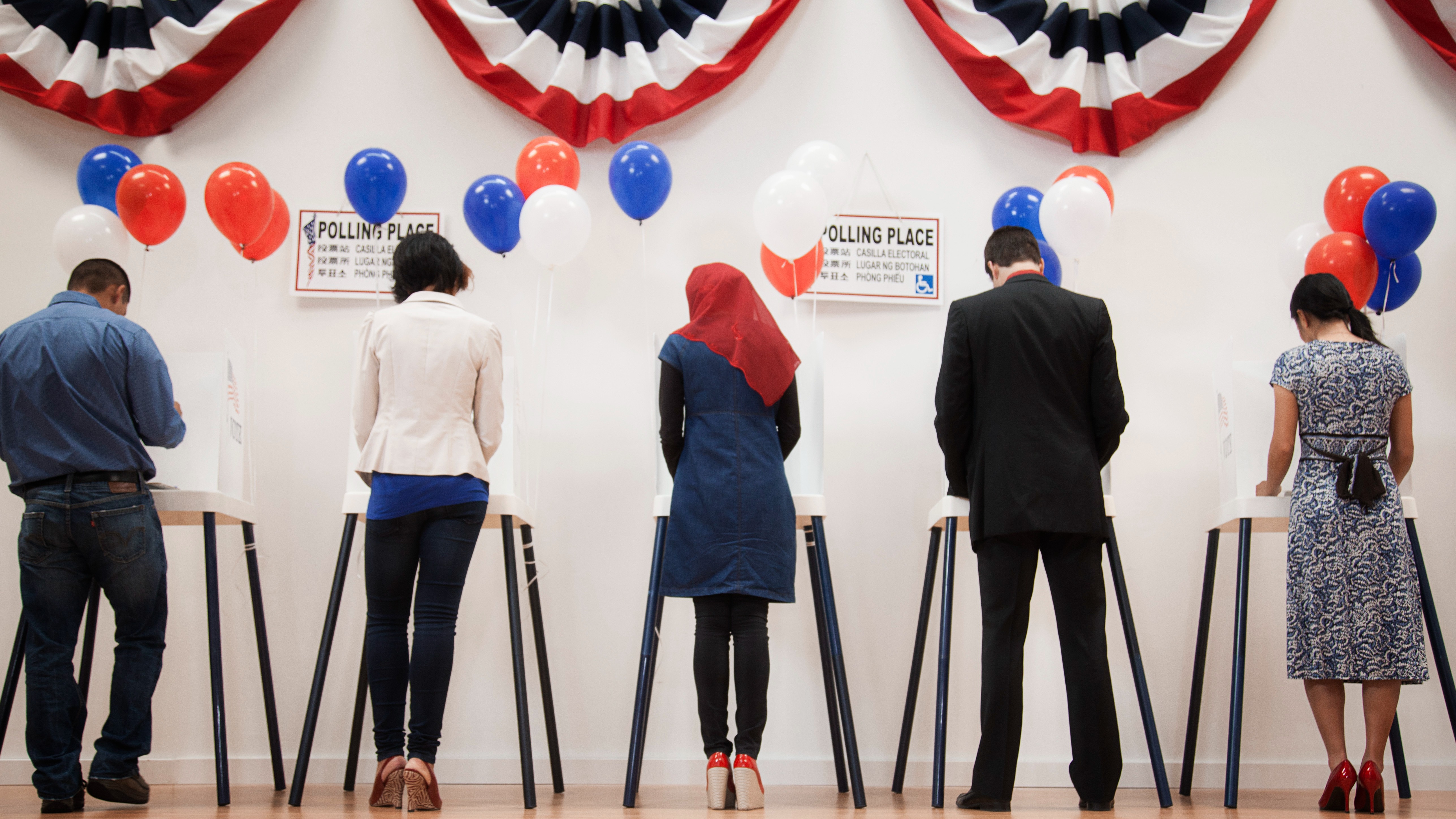 Voters stand in line to cast their ballots