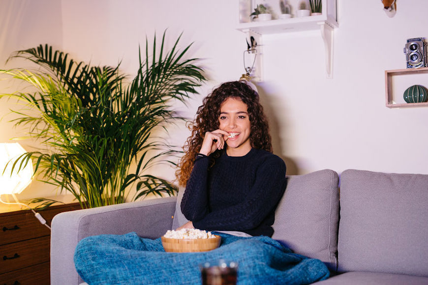 Featured image for Why snacking in front of the TV just feels so good, according to experts