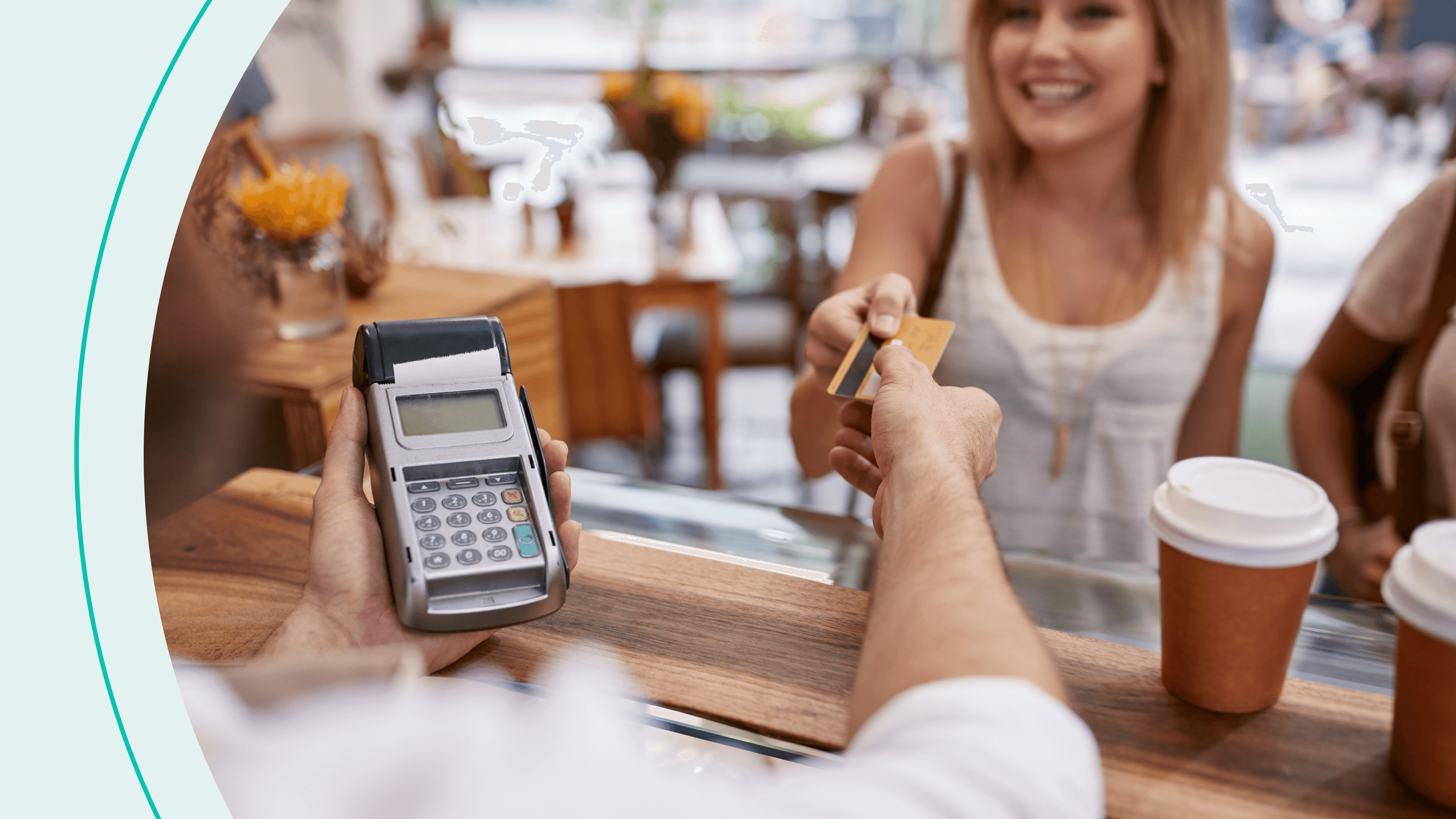 woman buying coffee with credit card at counter