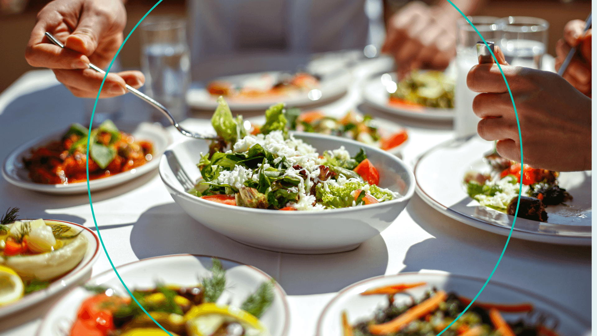 Photo of table with bowl of salad with cheese in the middle