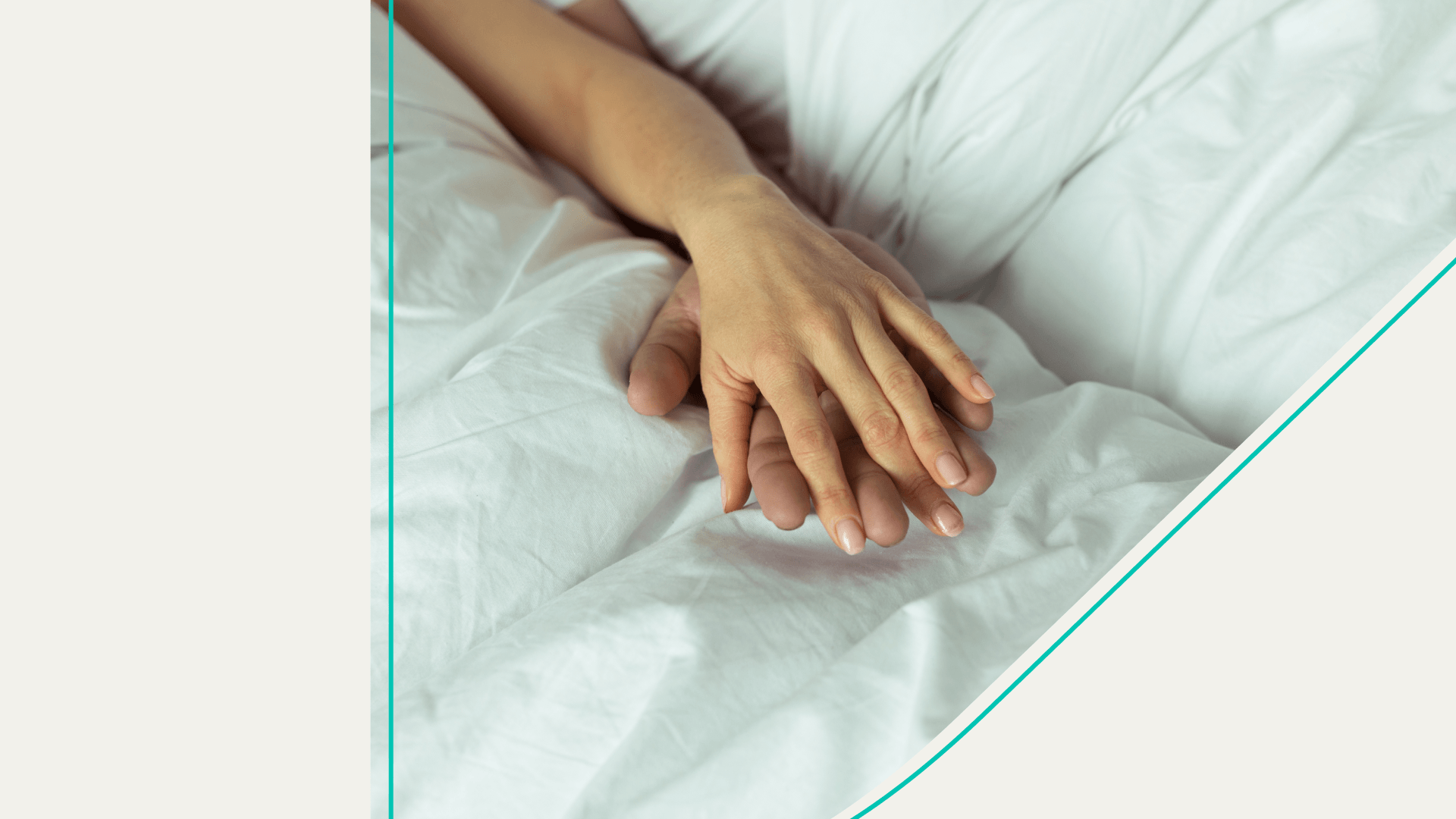 Two people holding hands in bed