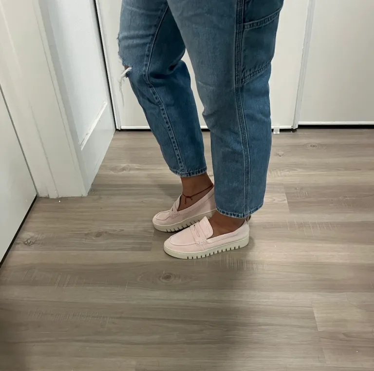 Woman in jeans wearing pink loafers