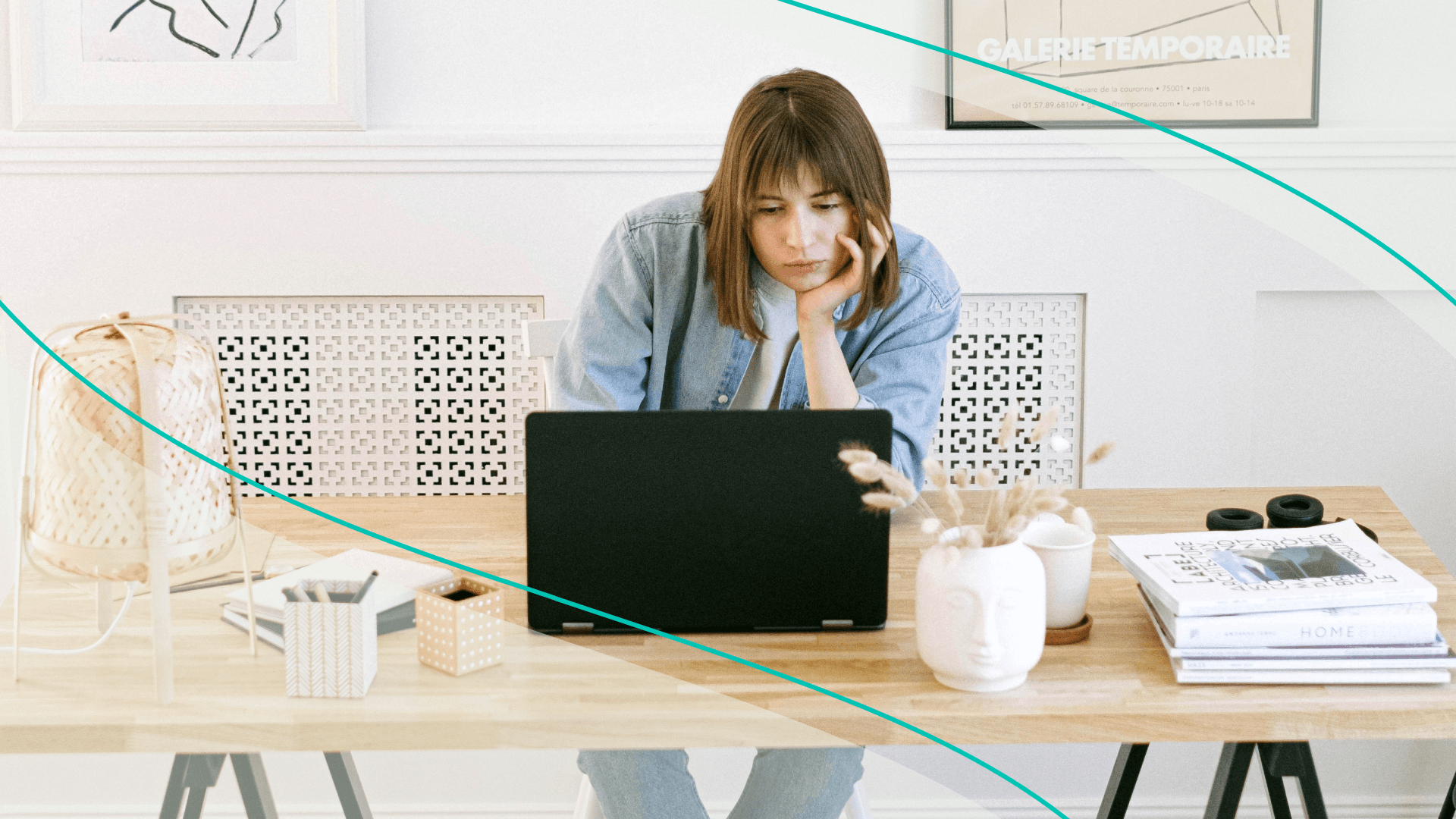 A woman at her desk with her chin in her hand