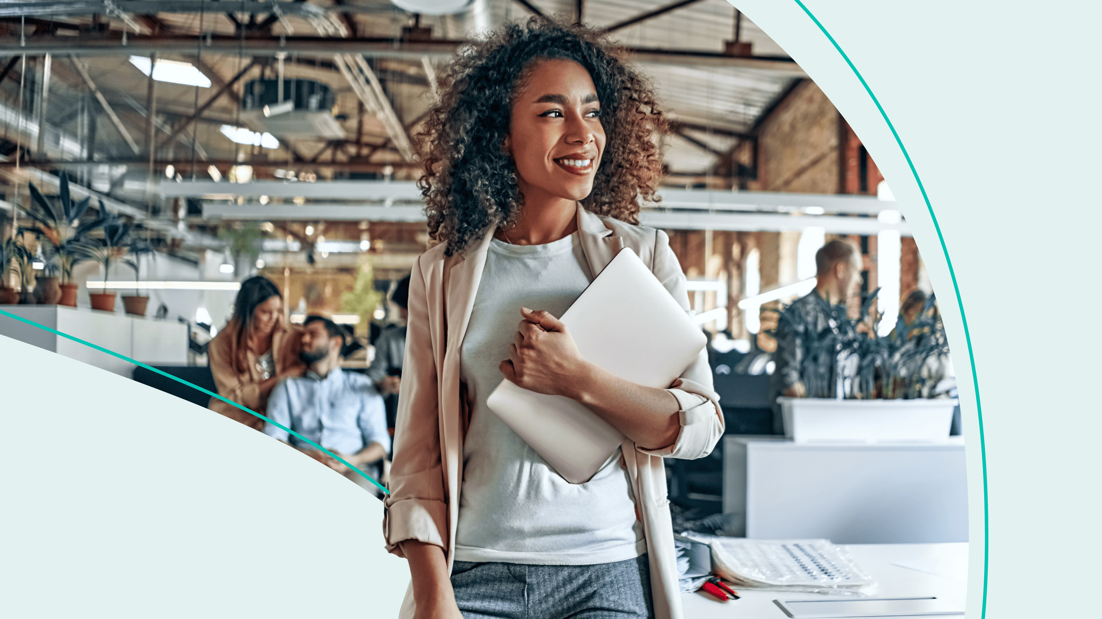 Woman holding laptop in an office