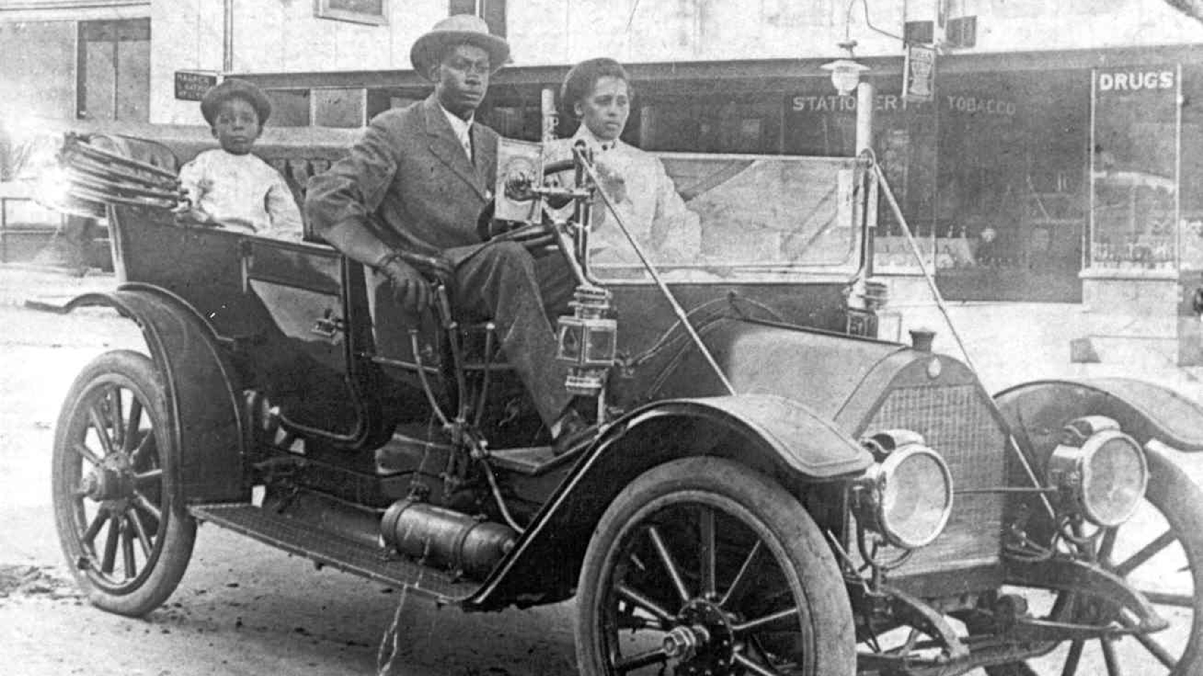 View of American businessman John Wesley Williams sits in his car with wife Loula Williams and their son, WD Williams, Tulsa, Oklahoma, 1910s