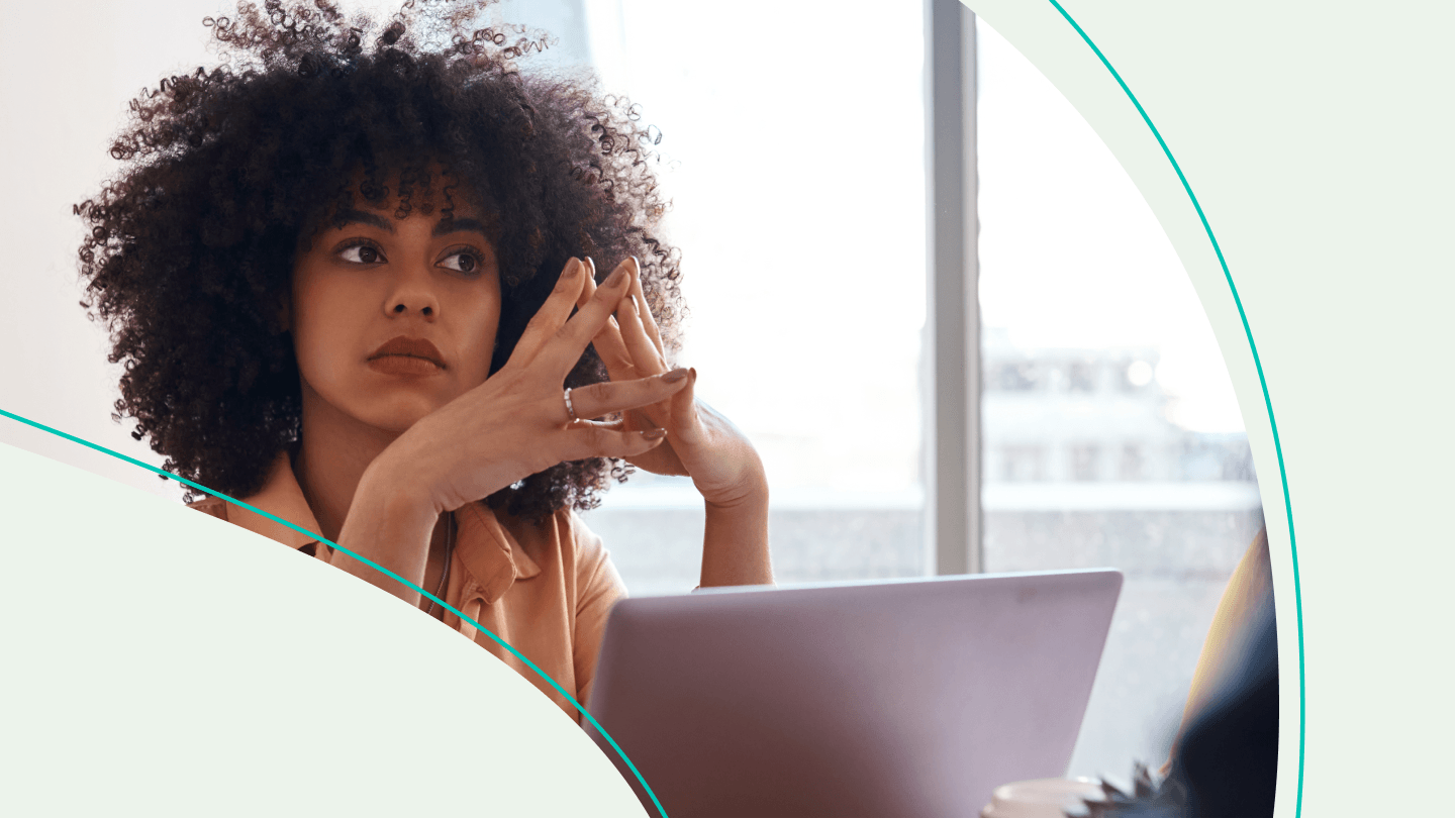 woman looks concerned in front of a laptop