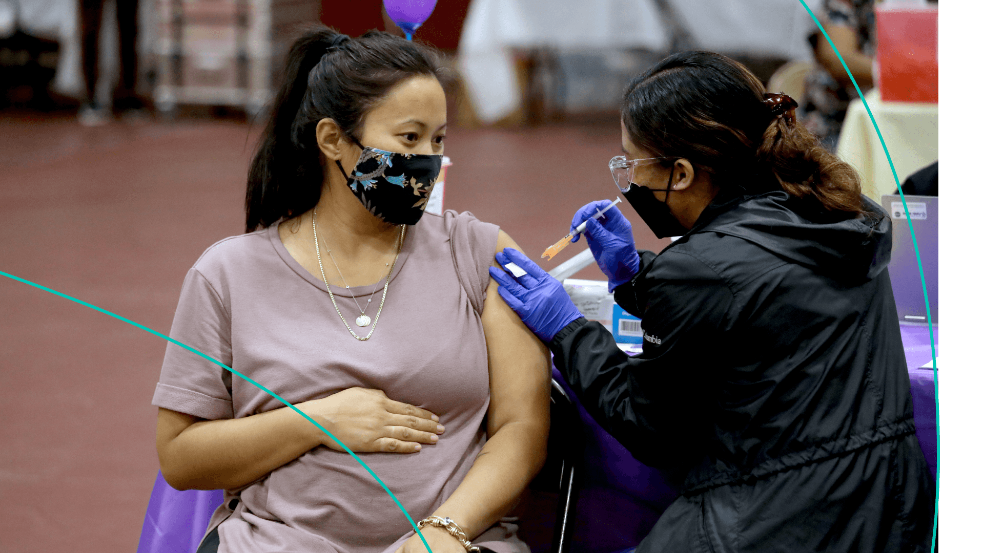 A pregnant woman gets a COVID-19 vaccine booster.
