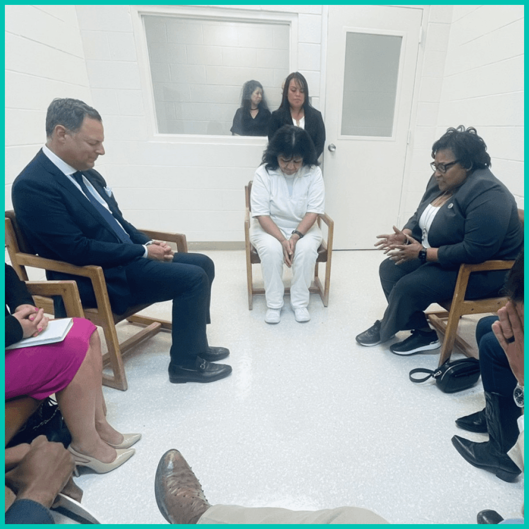 Melissa Lucio praying with a group of people.